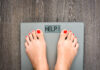 Lose weight concept with person on a scale measuring kilograms