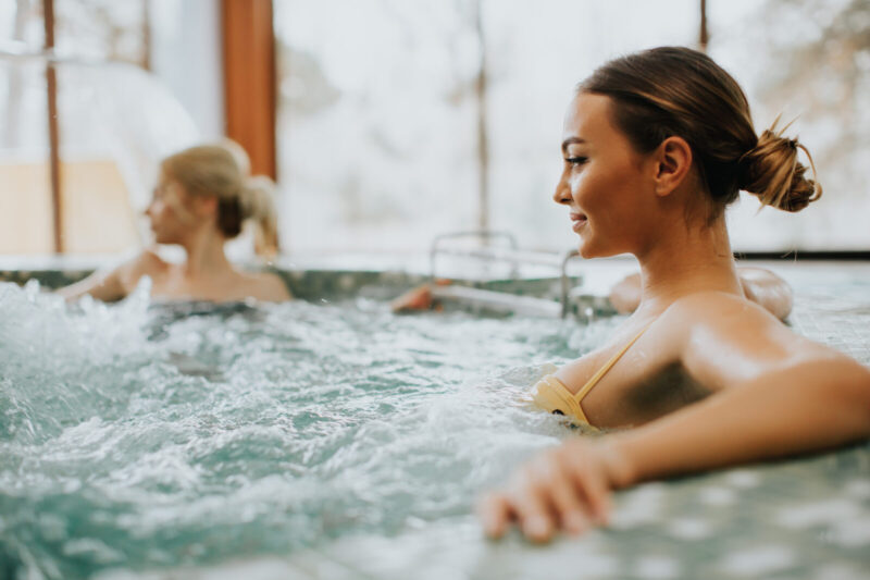 Young woman relaxing in the whirlpool bathtub