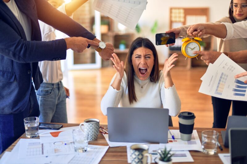 Group of business workers working together. Partners stressing one of them at the office