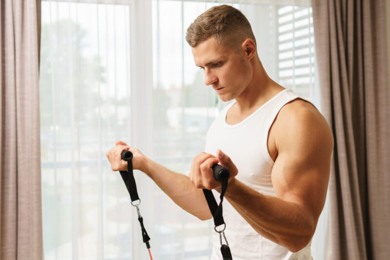 man during home workout with a resistance rubber bands