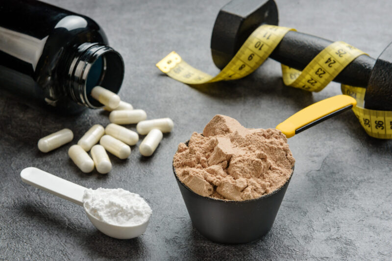 Scoops with protein and creatine close up. The concept of sports nutrition and supplements.